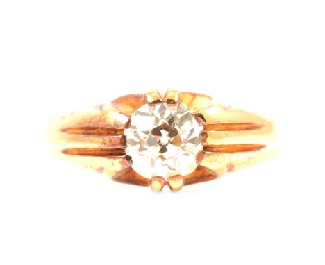 A diamond solitaire ring set in a gentleman's style mount, the old brilliant cut stone claw set in an all yellow metal mount 