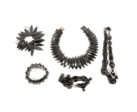 A collection of jet style jewellery, a 30mm wide expanding bracelet with oval faceted sections: a 30mm wide collar with marqu