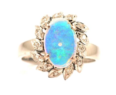 An opal and diamond cluster dress ring, the oval cabochon cut opal, 11.5 x 7.5mm, four claw set in an all white metal mount a