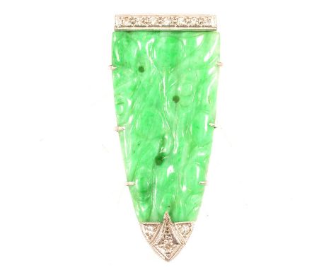 An Art Deco jade and diamond single dress clip, the 37mm arrow head clip having a carved jade centre and three 8 cut diamonds