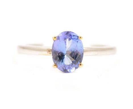 A tanzanite solitaire ring, the oval mixed cut stone, 8 x 6.2mm, four claw set in an 18 carat all white gold mount ring size 