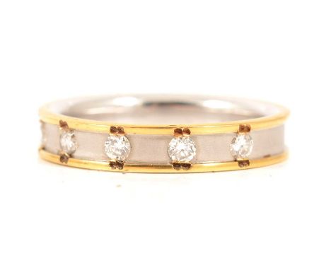 A diamond set 18 carat yellow and white gold band, five brilliant cut diamonds individually set in a 4mm white gold frosted b