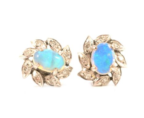 A pair of opal and diamond cluster earrings, the oval cabochon cut opals, 7 x 4mm, four claw set in all white metal mounts an