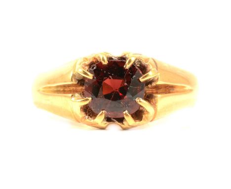 A Victorian 18 carat gold garnet ring, the oval mixed cut stone claw set in an all yellow gold mount ring size approximately 