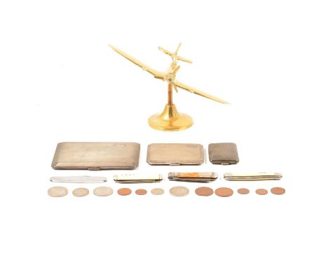 A brass model of a spitfire on a brass stand, 14cm; Commemorative nickel crowns and other pre-decimal coinage; a small engine
