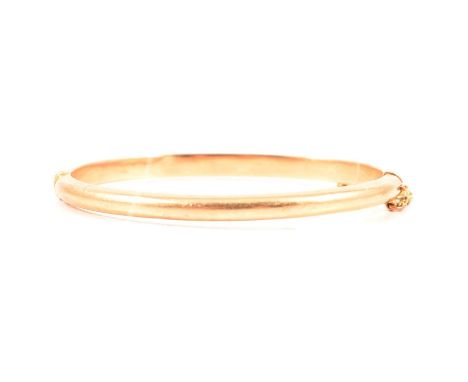 A child’s small half hinged bangle, 3.5mm plain polished hollow D shape section, tongue snap fastener marked 15ct, internal d