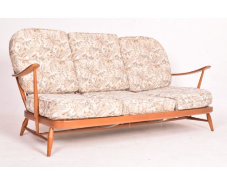 Ercol - A retro mid 20th century circa 1960s elm wood three seater sofa settee. The sofa raised on tapered rounded legs joine