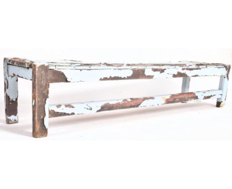 A 19th century vintage style rustic country light blue painted wooden outdoor garden bench rest. The bench of simple rectangu