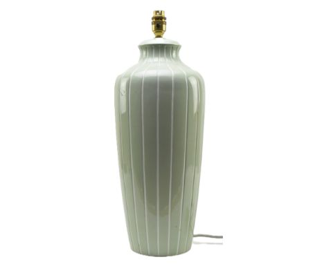 A vintage mid century Italian ceramic ribbed table lamp in light green colourway. The bedside lamp light of baluster form fea