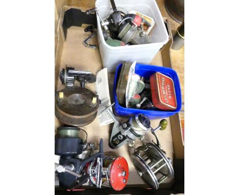 A collection of fishing reels, to include salmon reels, together with various lures and hooks 