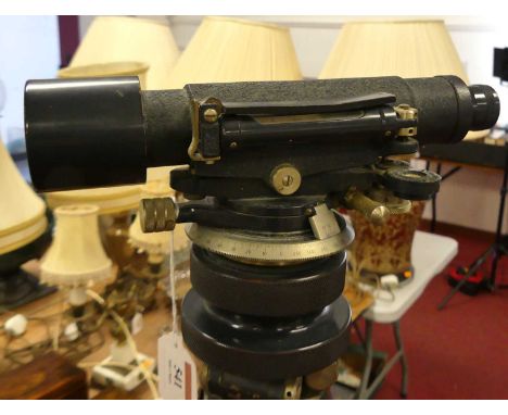 A Stanley theodolite, the tube with bubble level, rack and pinion action, on wooden tripod stand, tube length 23cm
