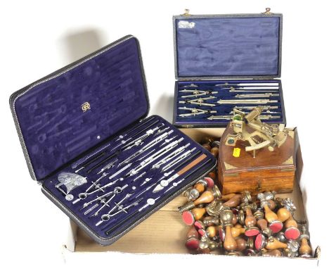 A collection of items to include a reproduction sextant, metal mounted, turned wooden chess set, and two cased sets of drawin