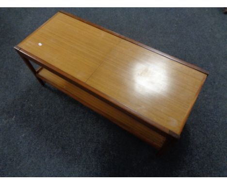 A 20th century teak extending coffee table with under shelf.