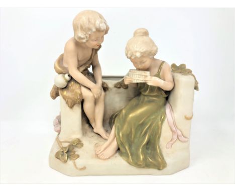 A Royal Dux figure group depicting two children playing a pipe whistle, height 24 cm. CONDITION REPORT: Pink triangular mark 