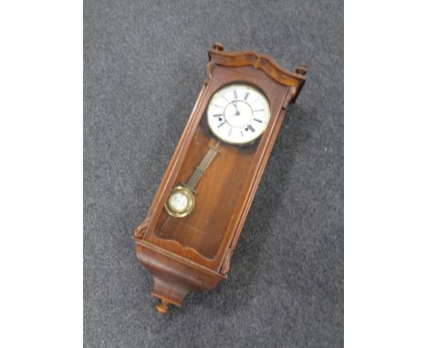 A 20th century mahogany cased eight day wall clock with brass and enamel dial.  