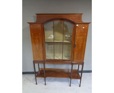 A late Victorian mahogany, satinwood strung and floral marquetry triple door display cabinet with glazed central door, on rai