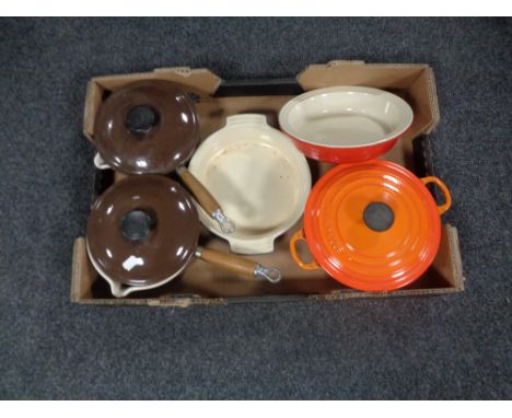 A box of Le Creuset cast iron and ceramic oven dishes and lidded pans 
