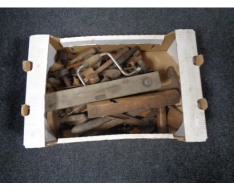 A box containing 20th century woodworking tools and spirit levels. 