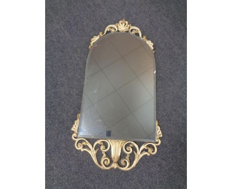 A cream and gilt framed arch topped bevel edged mirror. 