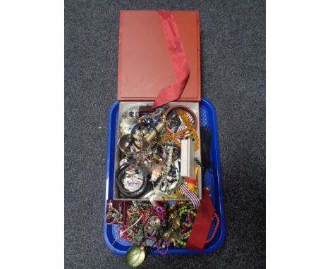 A tray containing a large quantity of assorted costume jewellery to include bangles, lady's Ira wristwatch on bracelet strap,