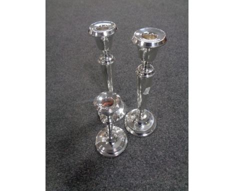 A pair of silver tapered stem candlesticks, height 29 cm, together with a further silver candlestick, height 20 cm.