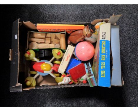 A box containing vintage toys to include Ring Toss and shooting game, wooden blocks, pull along toys, money boxes etc.  