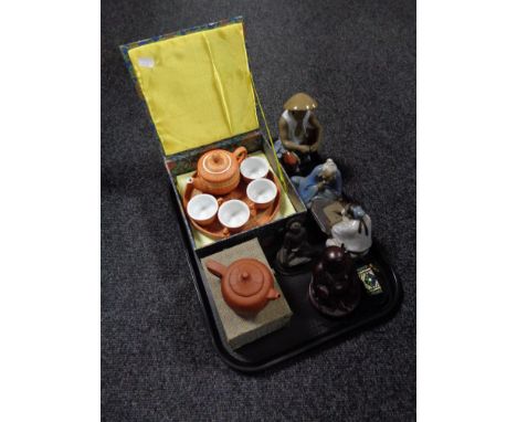 A tray containing oriental style Japanese figures, resin Buddha's, boxed Chinese style china and wicker six piece tea service