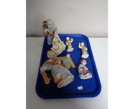 A tray containing six oriental figures. 