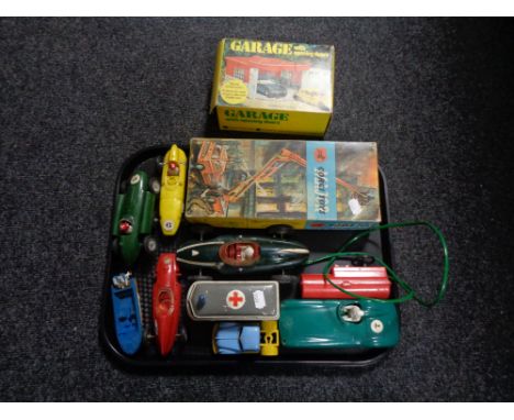 A tray of boxed Corgi 1127 fire engine, boxed garage with opening doors and further mid 20th century made in Hong Kong plasti