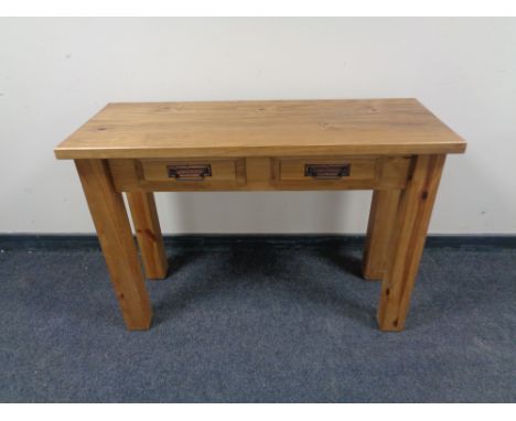 A Mexican pine console table fitted two drawers 