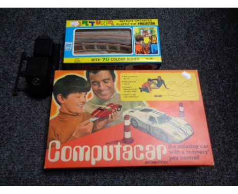 A boxed mid 20th century Mettoy Computacar and a Fortuna battery operated plastic toy projector 