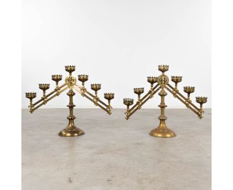 A pair of bronze candelabra with adjustable arms, and 7 candle holders. Decor of Fleur De Lis.&nbsp;Dimensions:(W:76 x H:52 c