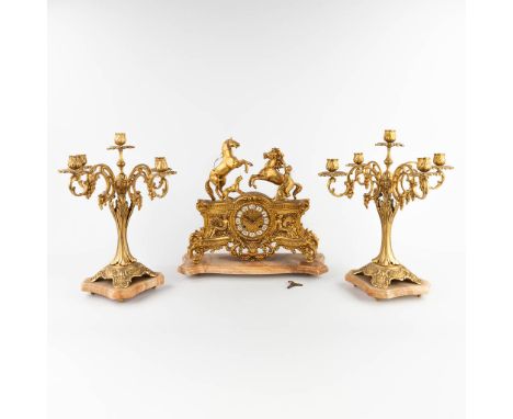A three-piece mantle garniture clock and candelabra polished bronze.Decorated with marly horses.&nbsp;20th century.&nbsp;Heig