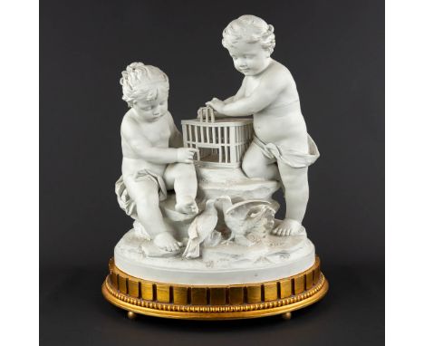 Two children with a birdcage and pidgeons, bisque porcelain. Signed 'Marion'The first half of the&nbsp;20th century.&nbsp;Dim