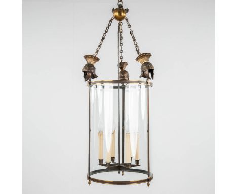 A hall lamp, bronze and glass, decorated with Roman helmets.20th century.&nbsp;Dimensions:(H:102 x D:40 cm)