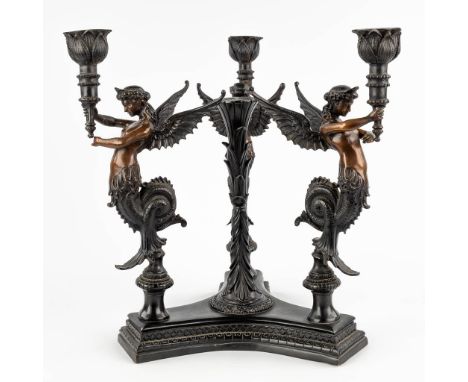 A large table candelabra decorated with three 'Mélusines', patinated bronze. 20th C.Melusines are fairies with a mermaid's ta