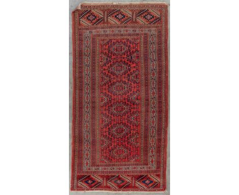 An Oriental hand-made carpet.&nbsp;Dimensions:(D:226 x W:119 cm)