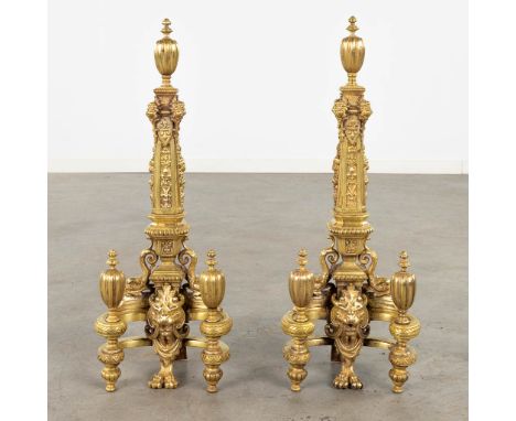 A pair of fireplace bucks, gilt bronze decorated with lion's and putti heads.19th century.&nbsp;Dimensions:(D:16 x W:23 x H:6