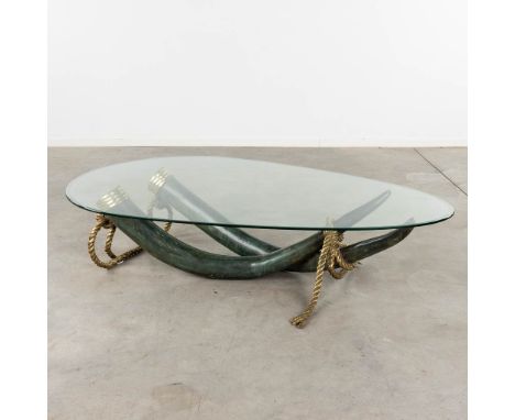 A coffee table, faux tusks, patinated bronze,Valenti, Spain.Signature not found.&nbsp;Circa 1980.Dimensions:(D:100 x W:168 x 