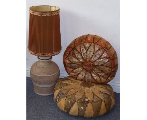 An African pottery table lamp with shade decorated with abstract style shapes together with two hand-stitched Ethiopian leath