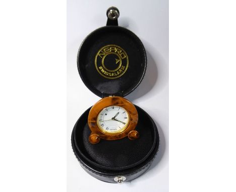 A miniature Missiaglia&nbsp;travel alarm clock; faux-tortoiseshell enamel case surrounding a white-enamel dial with Roman num