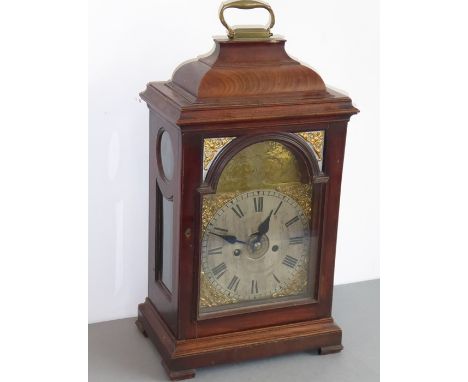 A large antique, mahogany-cased bracket clock,; brass swing-handle above nicely figured mahogany case and the seven-inch brok