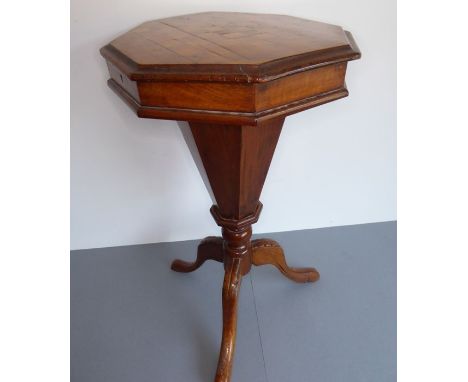 A 19th century octagonal walnut work table;&nbsp;chessboard-topped,&nbsp;fitted interior above a tapering octagonal stem and 