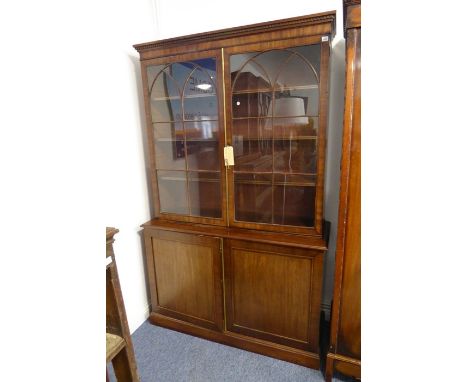 A freestanding mahogany bookcase in Georgian style (probably the earlier top half married to a late 19th/early 20th century b