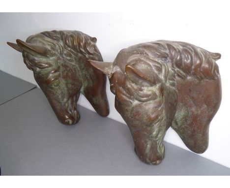 A heavy pair of wall-mounted, ornamental bronze horses heads (20cm)