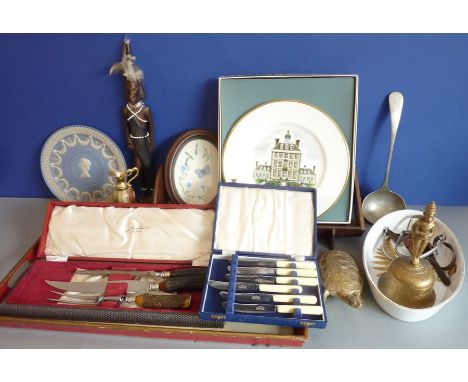 An assortment of items to include an early 20th century wooden book rack, cased carving set, Tibetan-style brass bell, Africa