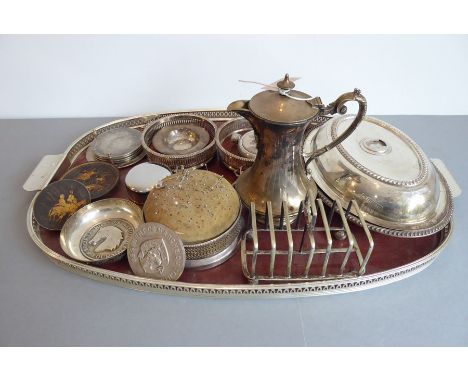 A selection of mostly early 20th century silver plate to include an oval entrée dish and cover (minus handle), a ladle, a six