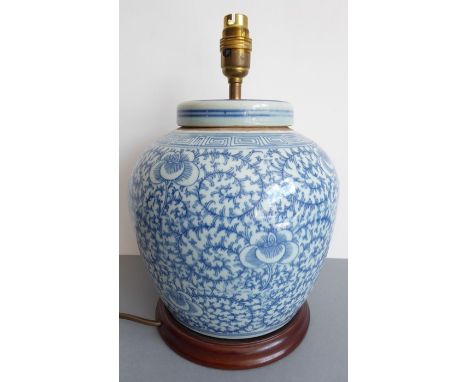 A Chinese ginger jar and cover (now as a lamp) decorated in under-glaze blue with a key-fret border above scrolling lotus etc