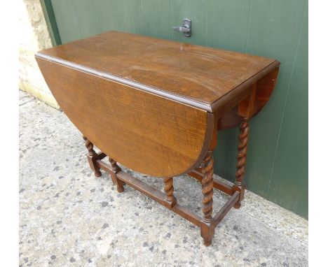 An oak barley-twist gate-leg table