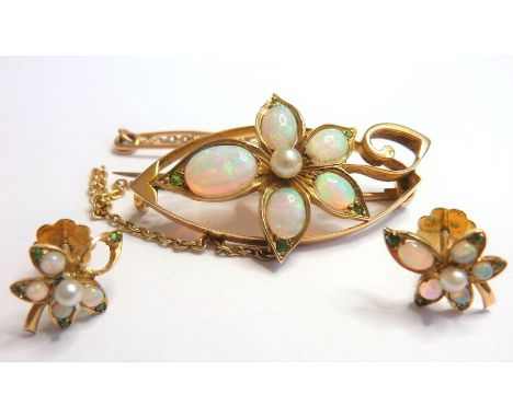 An Edwardian yellow-gold brooch mounted with opals in the flower-head design together with a pair of similar earrings (single